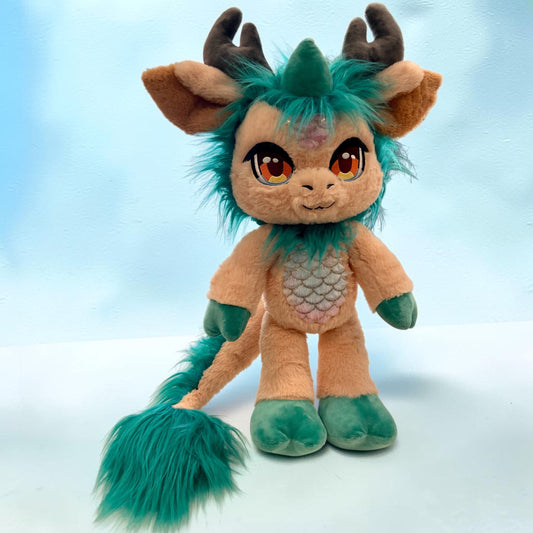 Alternate front standing view of Kaleido the Kirin, a peach, teal, brown kirin plush.