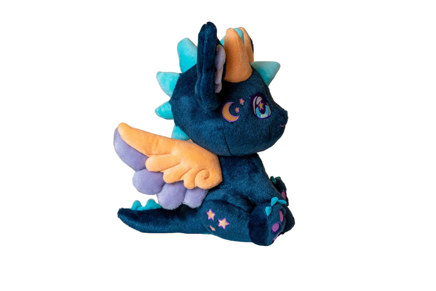 Three-quarter cutout view of Calypso, a navy, peach, turquoise dragon plush.