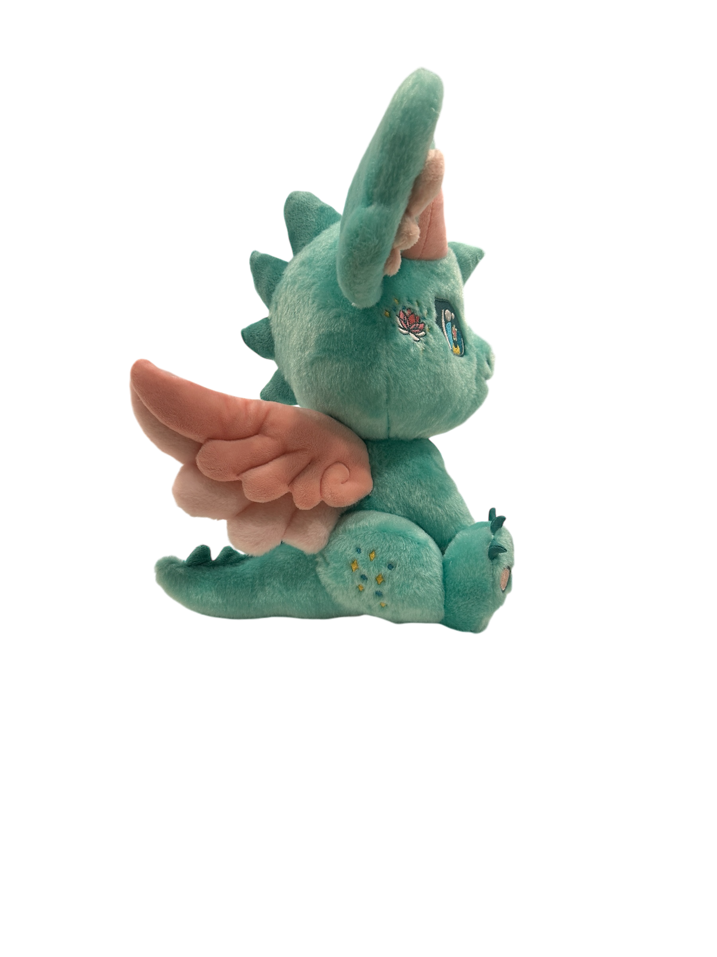 Side cutout view of Ren, a mint, pink, turquoise dragon plush.