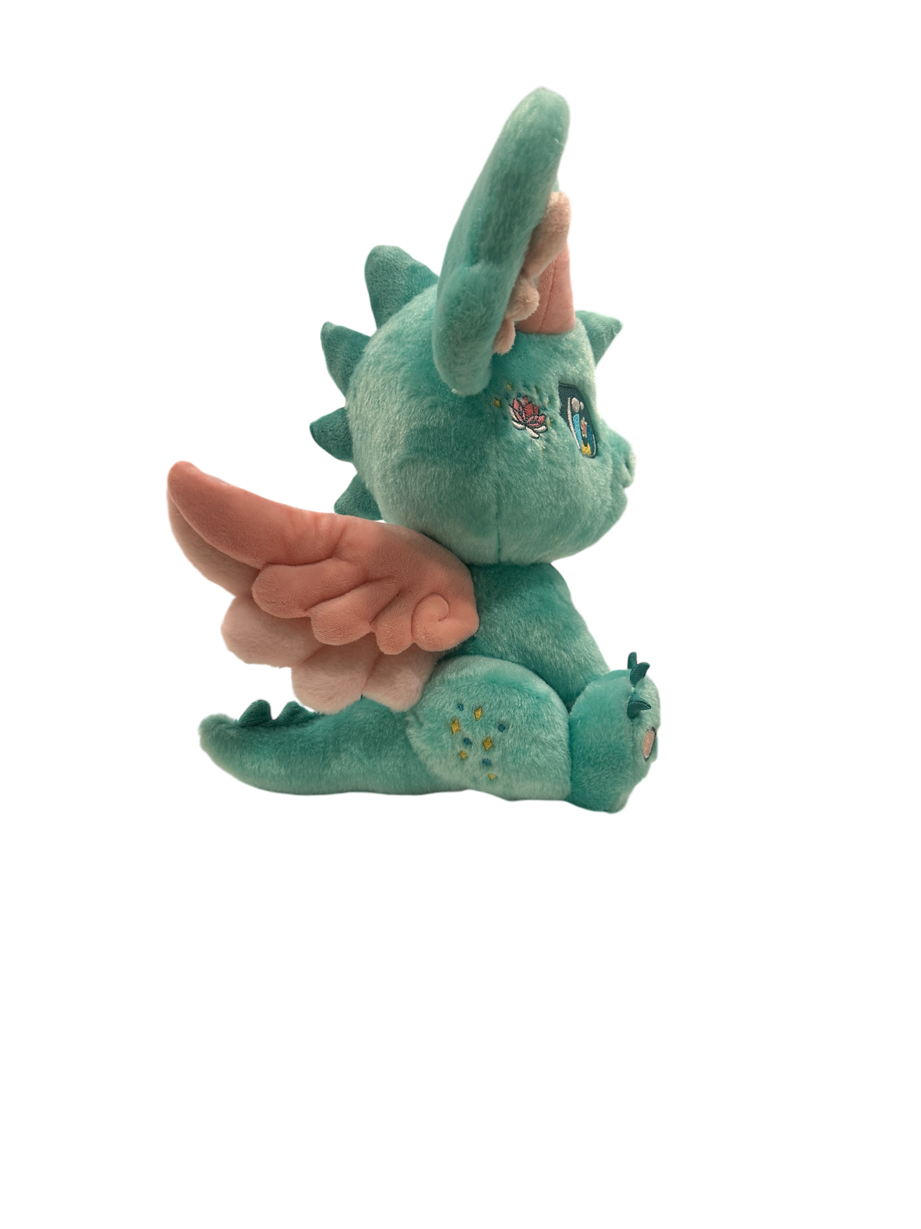 Side cutout view of Ren, a mint, pink, turquoise dragon plush.