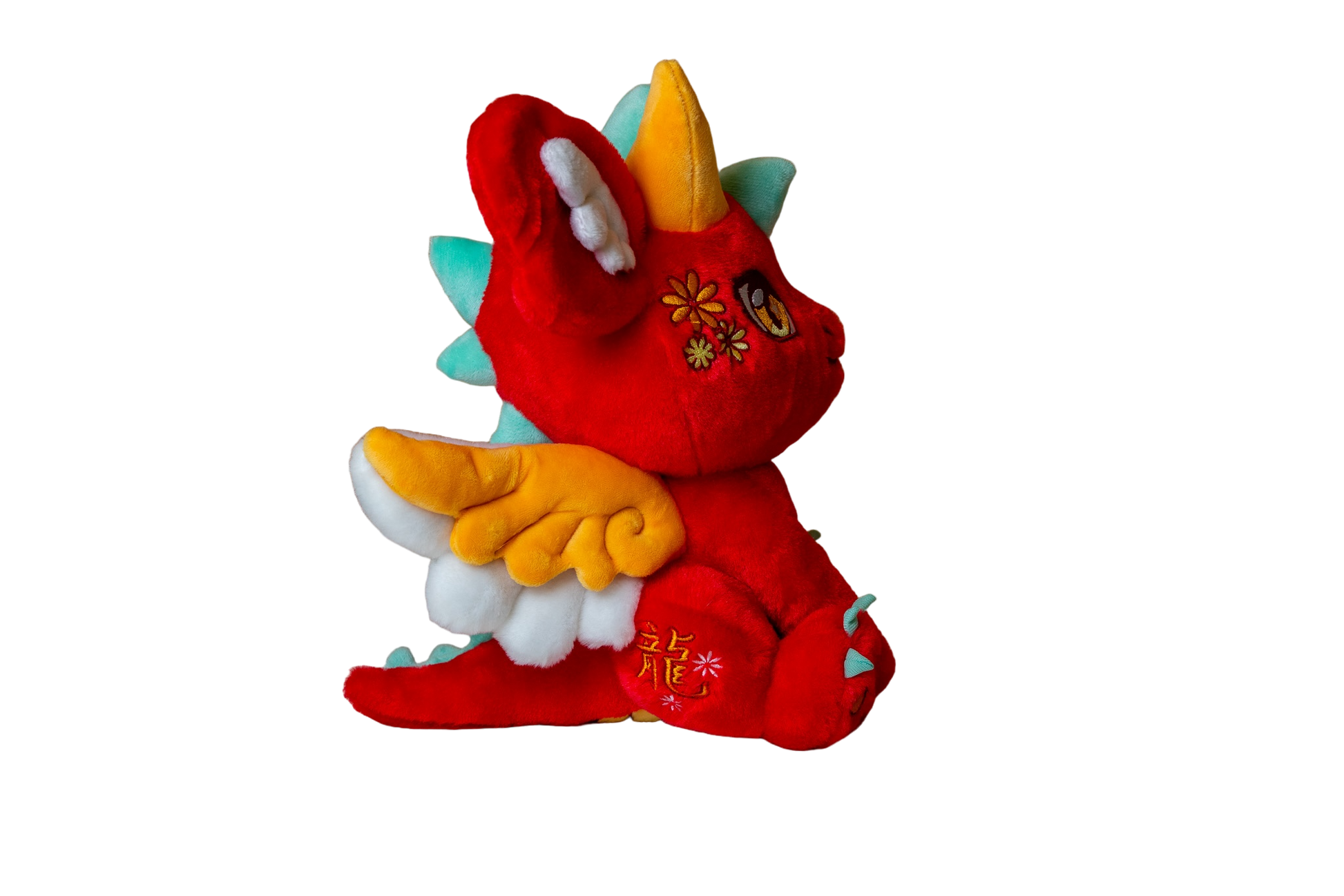 Three-quarter cutout view of Ryu, a red, orange, turquoise dragon plush.