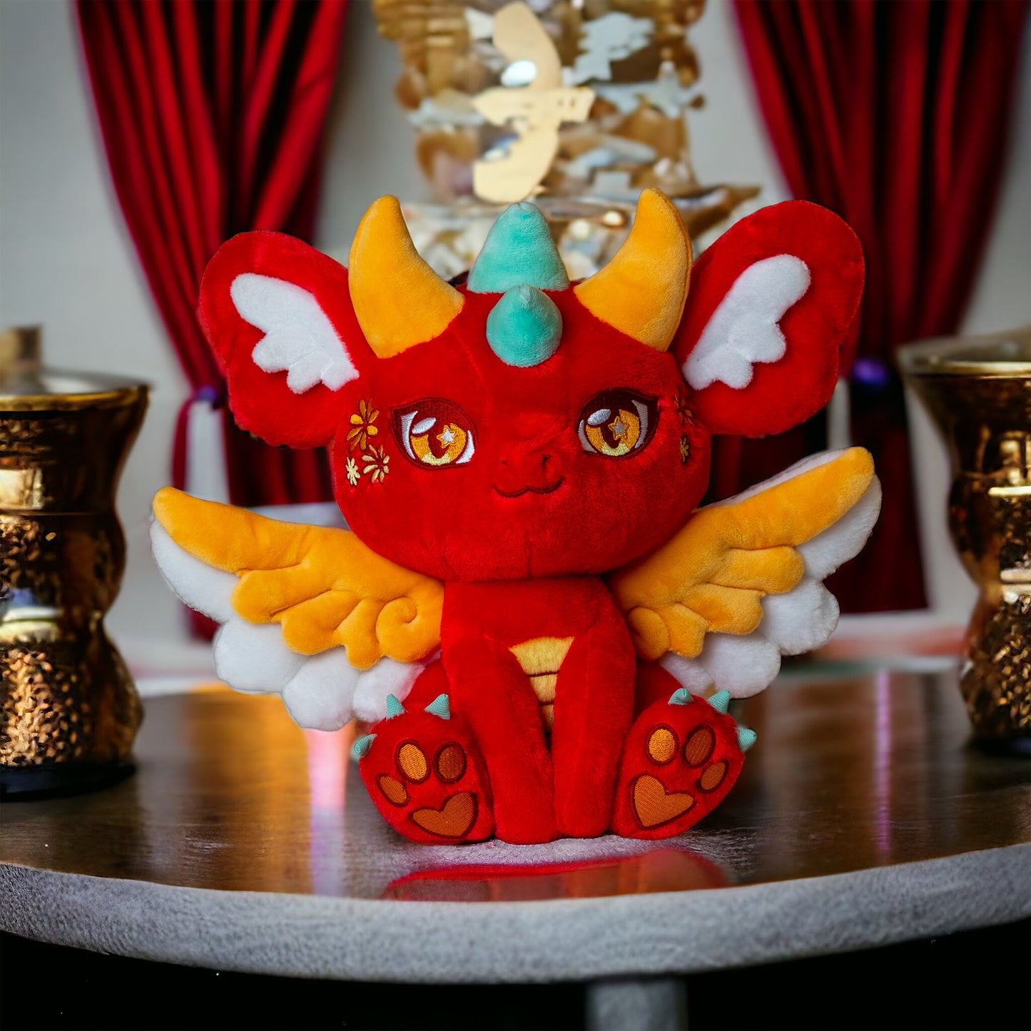 Interior lifestyle image of Ryu, a red, orange, turquoise dragon plush.