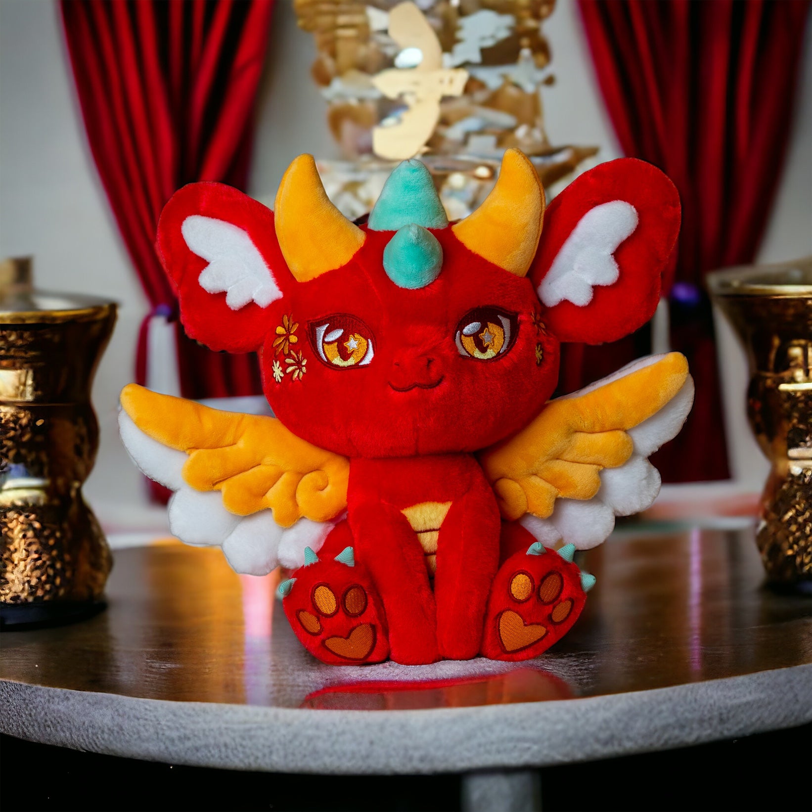 Interior lifestyle image of Ryu, a red, orange, turquoise dragon plush.